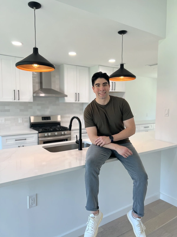 Photo of Marcus Flores, Founder of Waterloo Construction in a kitchen that he renovated