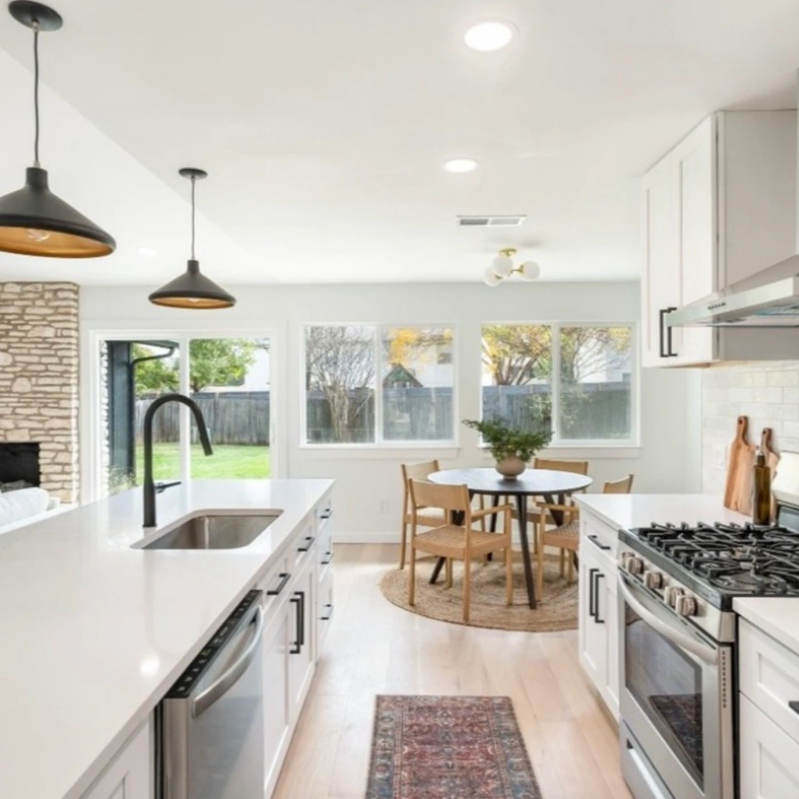 Bright modern kitchen remodel with white cabinets, stainless appliances, and breakfast nook