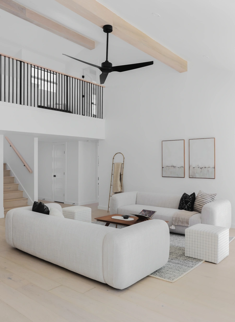 Open concept living room with upper balcony view