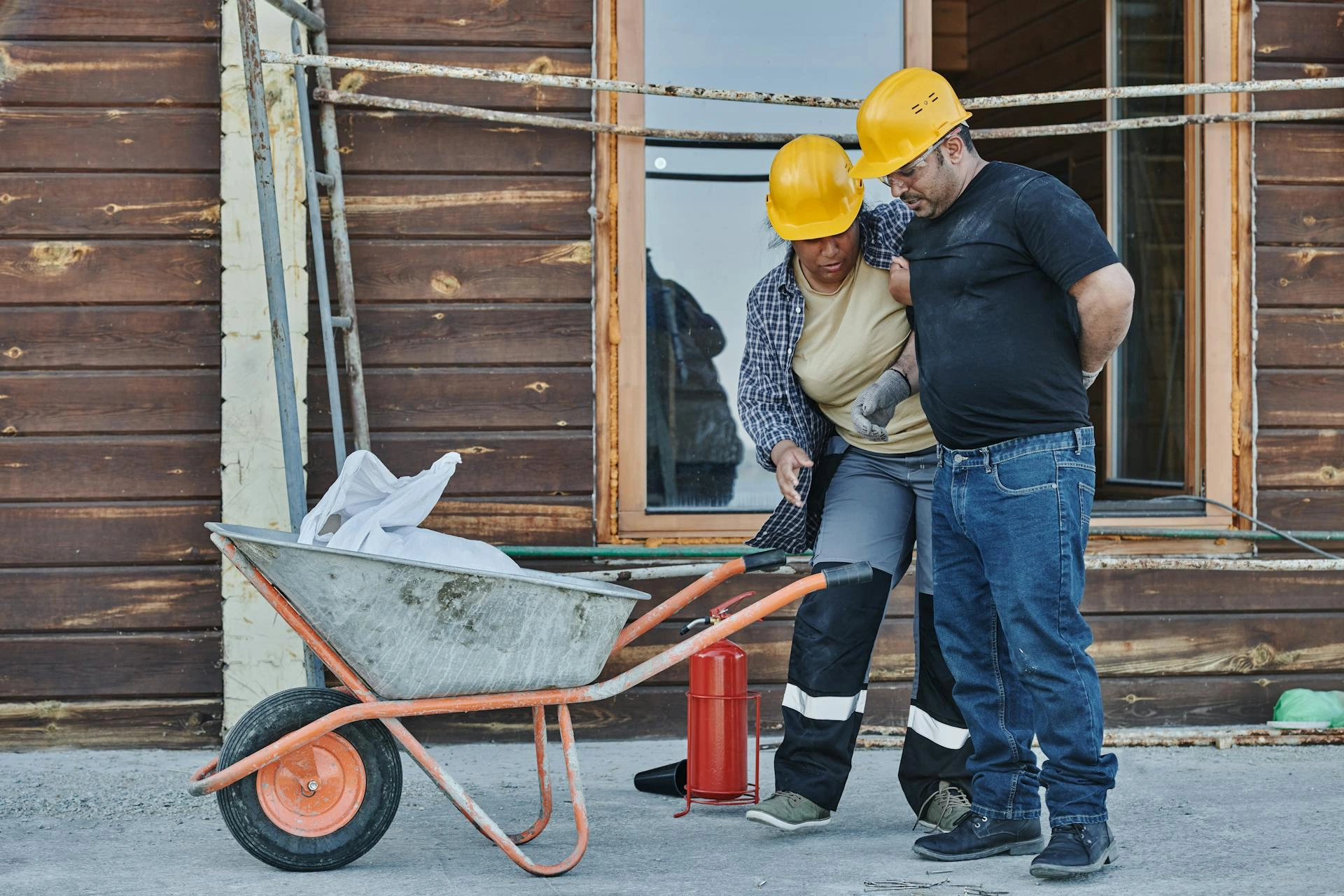 Coworker helping an injured colleague on a construction site